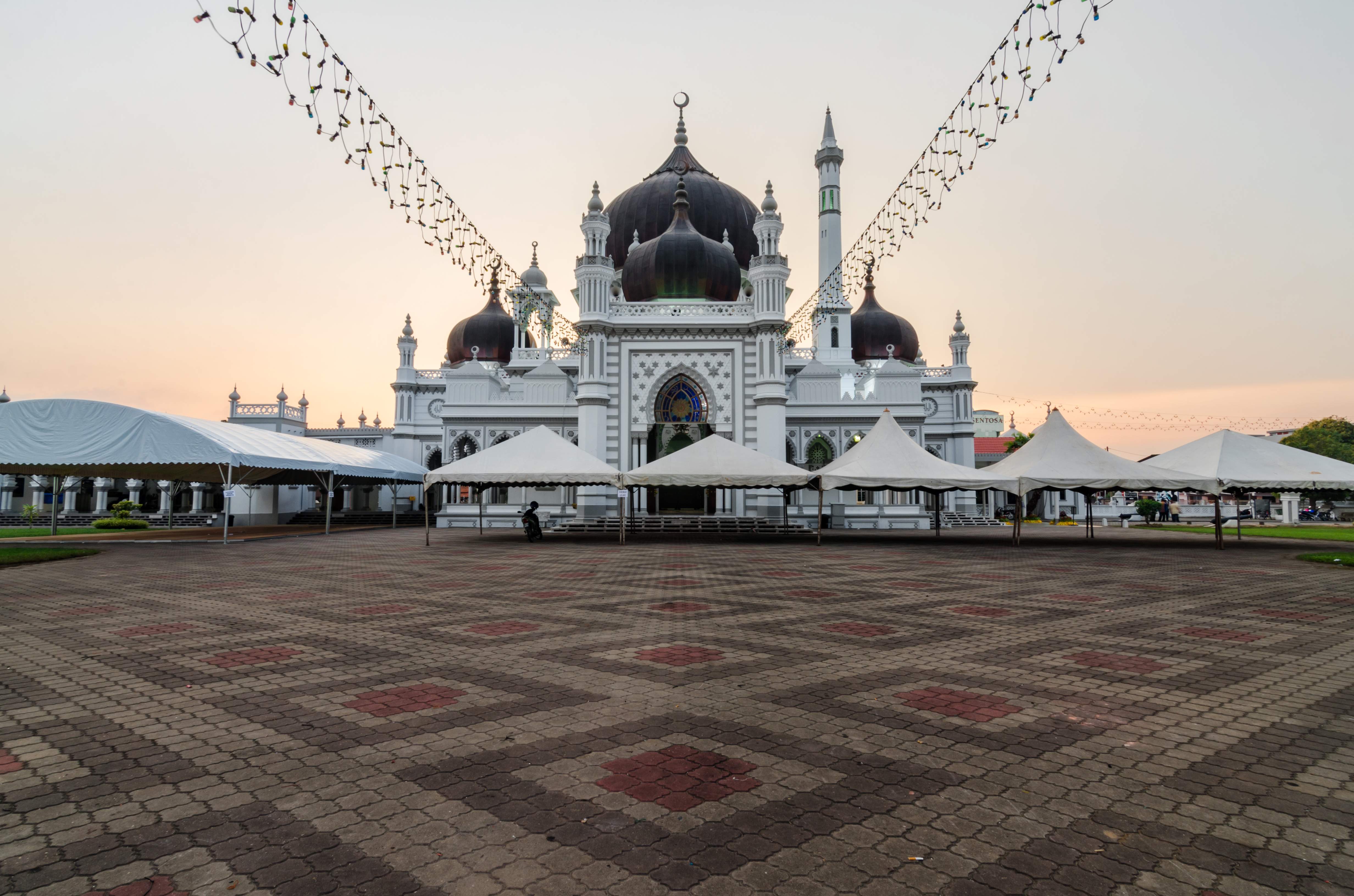Masjid Zahir, with its dark domes and illuminated facade.