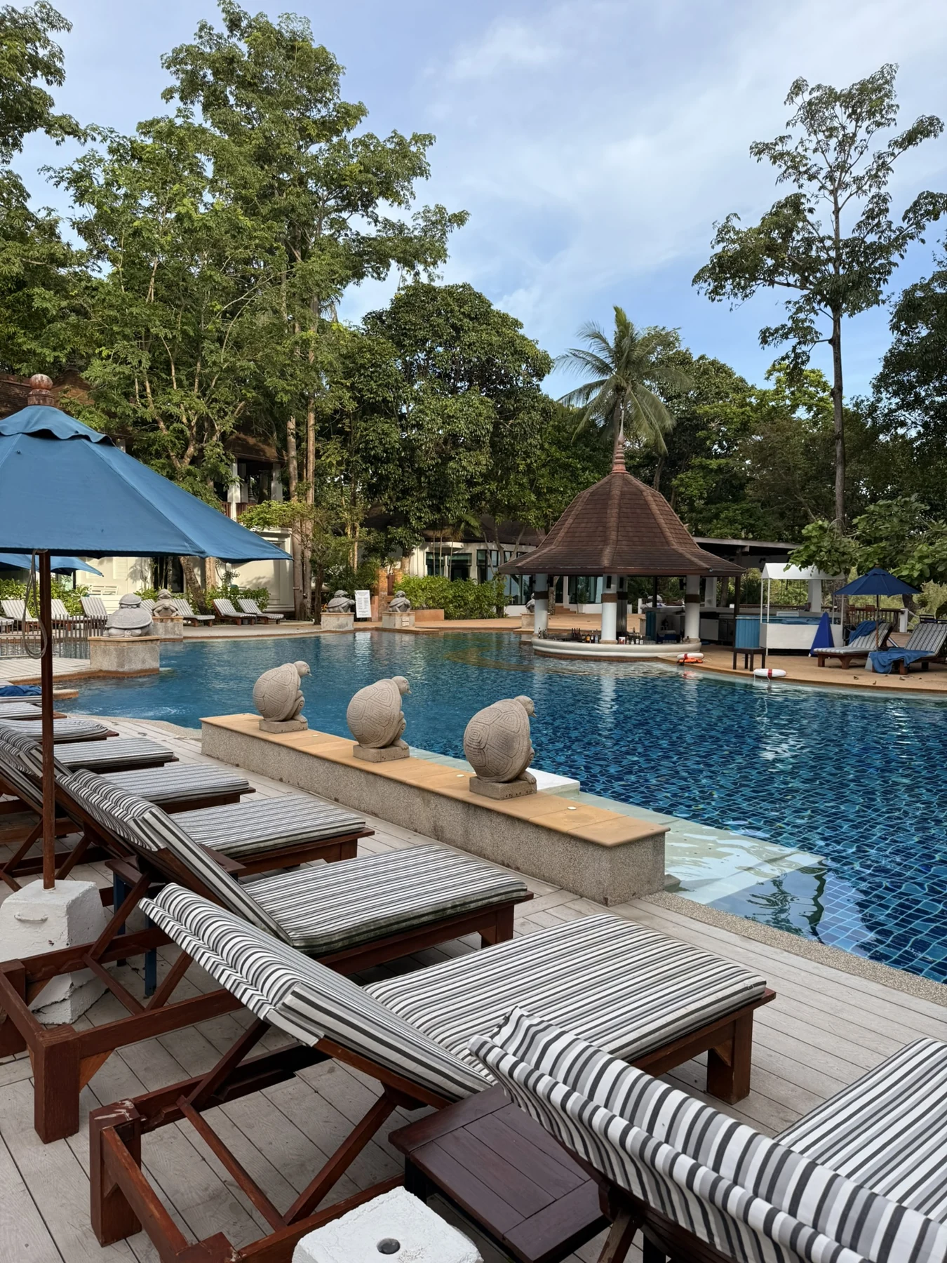 Pool and sun loungers at Avani+ Koh Lanta Krabi Resort, Thailand.