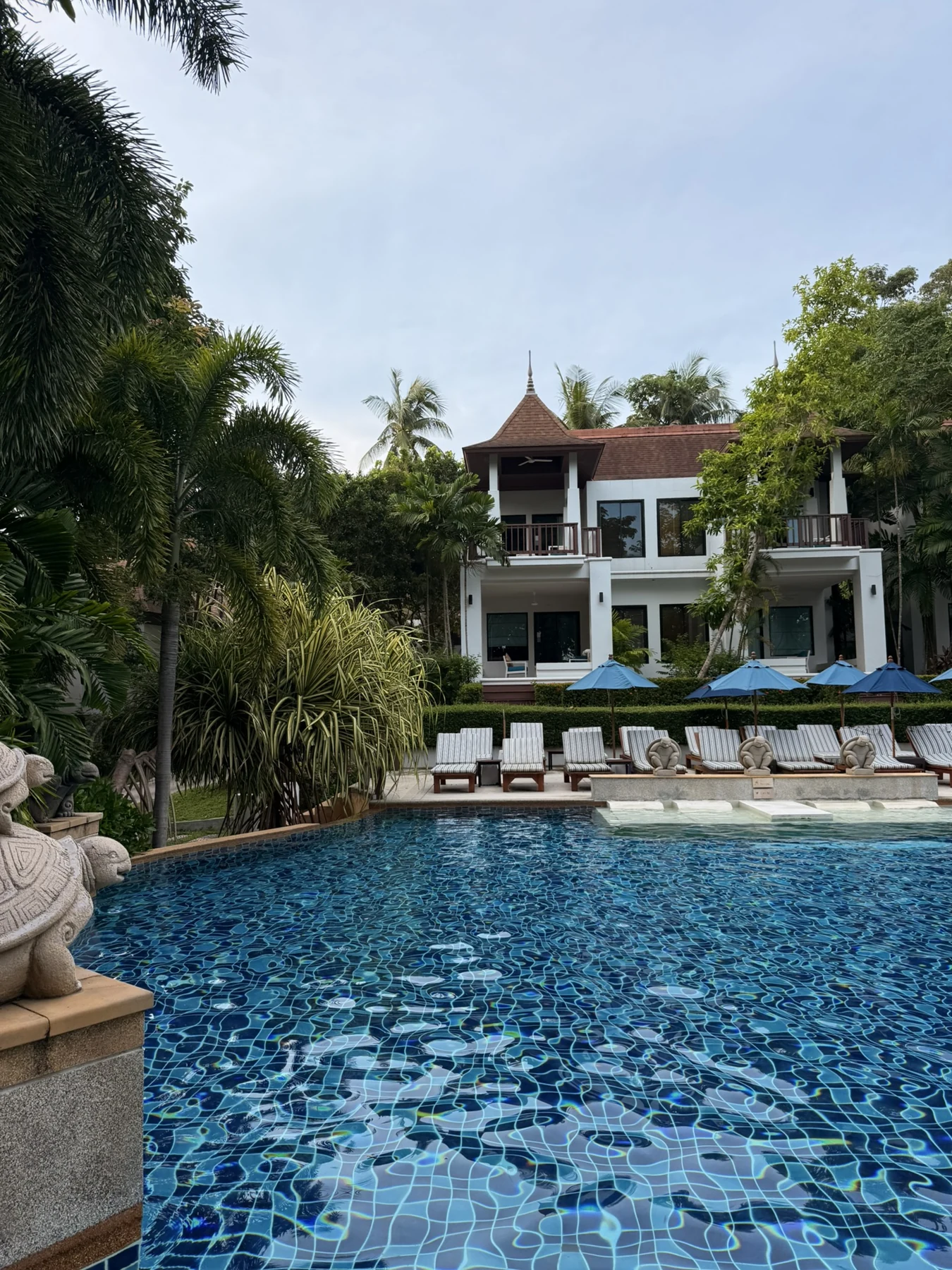 The pool surrounded by gardens and resort buildings. Koh Lanta, June 2025.