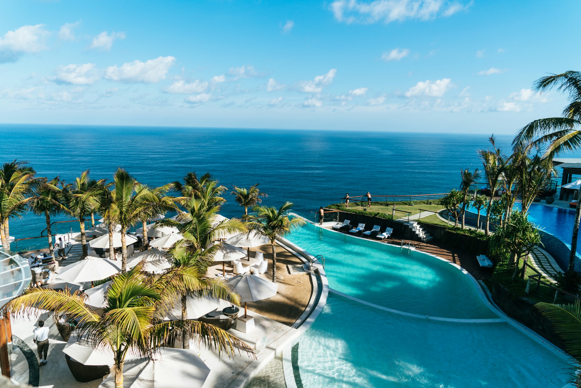Palm-lined pool and an open tropical sky
