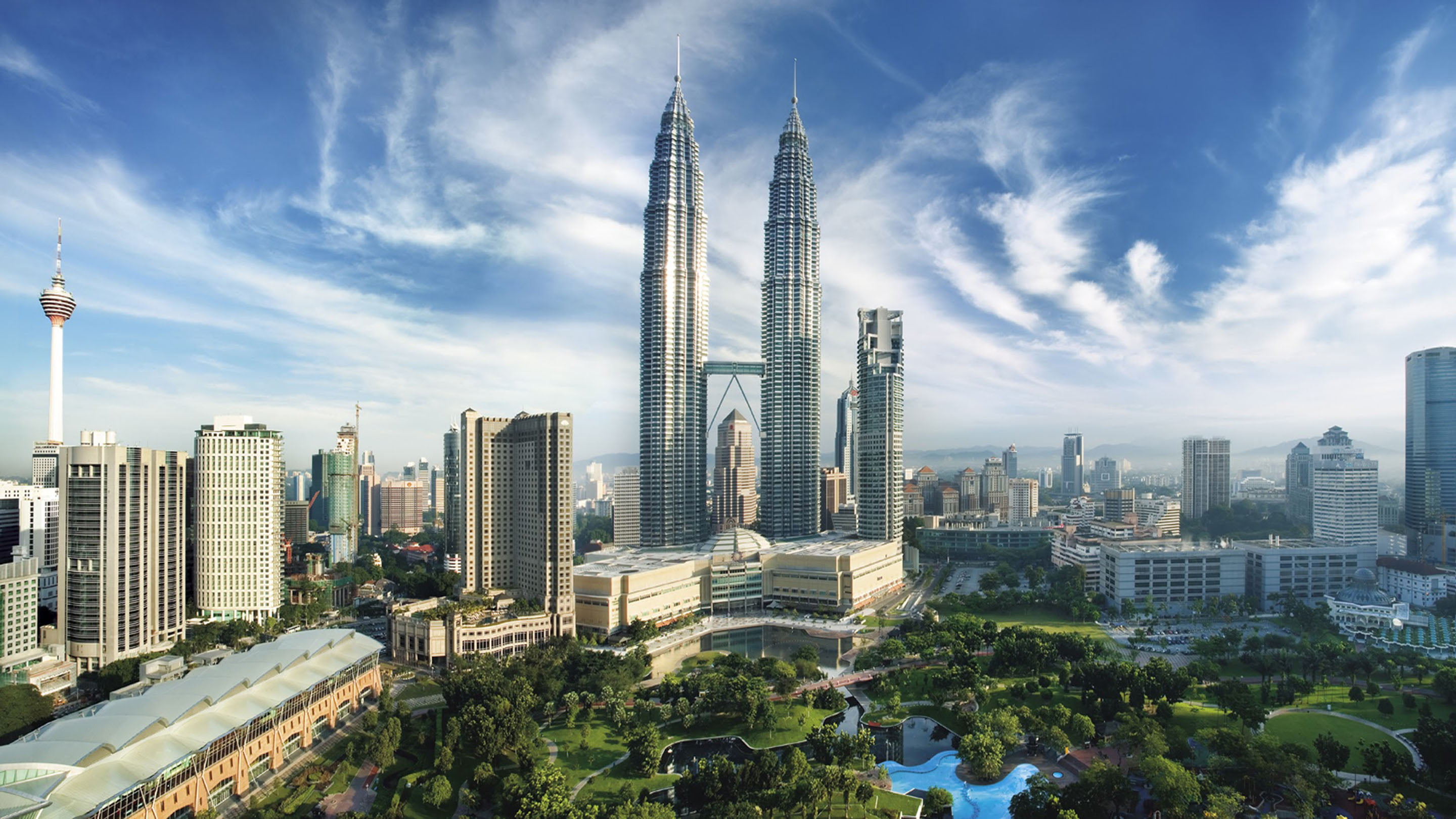 Kuala Lumpur skyline with the Petronas Twin Towers, KL Tower and KLCC Park.