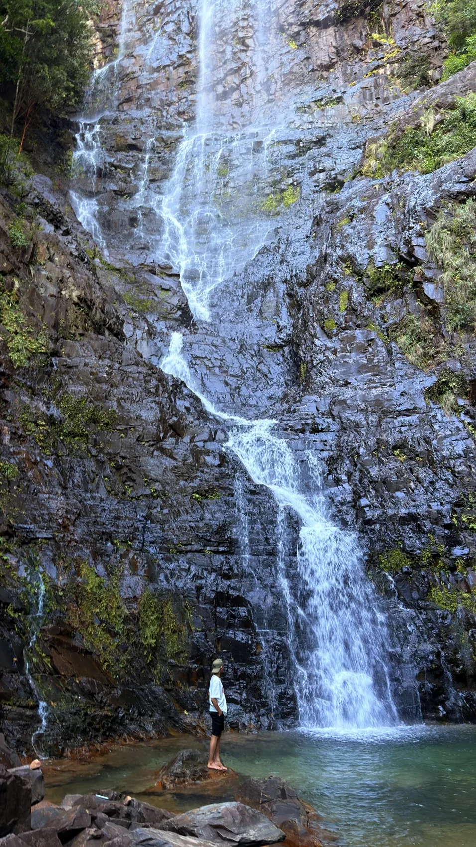 Air Terjun Temurun, dengan dinding batu tinggi dan kolam di kakinya.