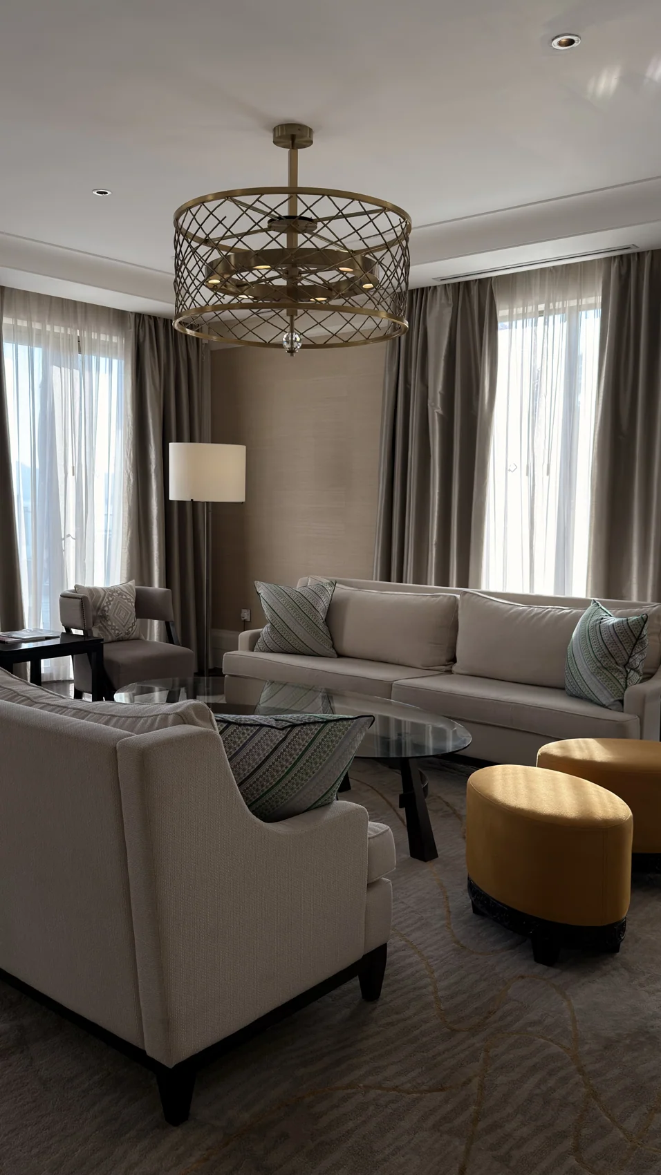 Ruang tamu suite dengan sofa, meja kopi dan tingkap besar.