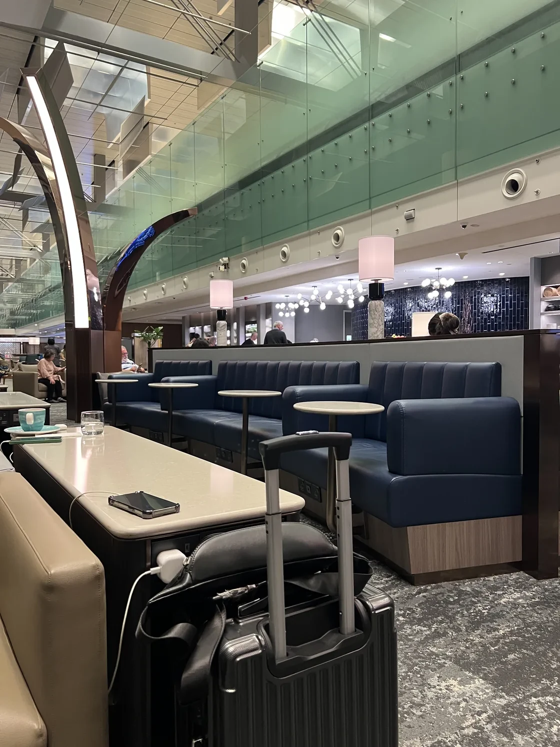 KrisFlyer Gold Lounge seating in Changi beside the terminal’s open concourse.