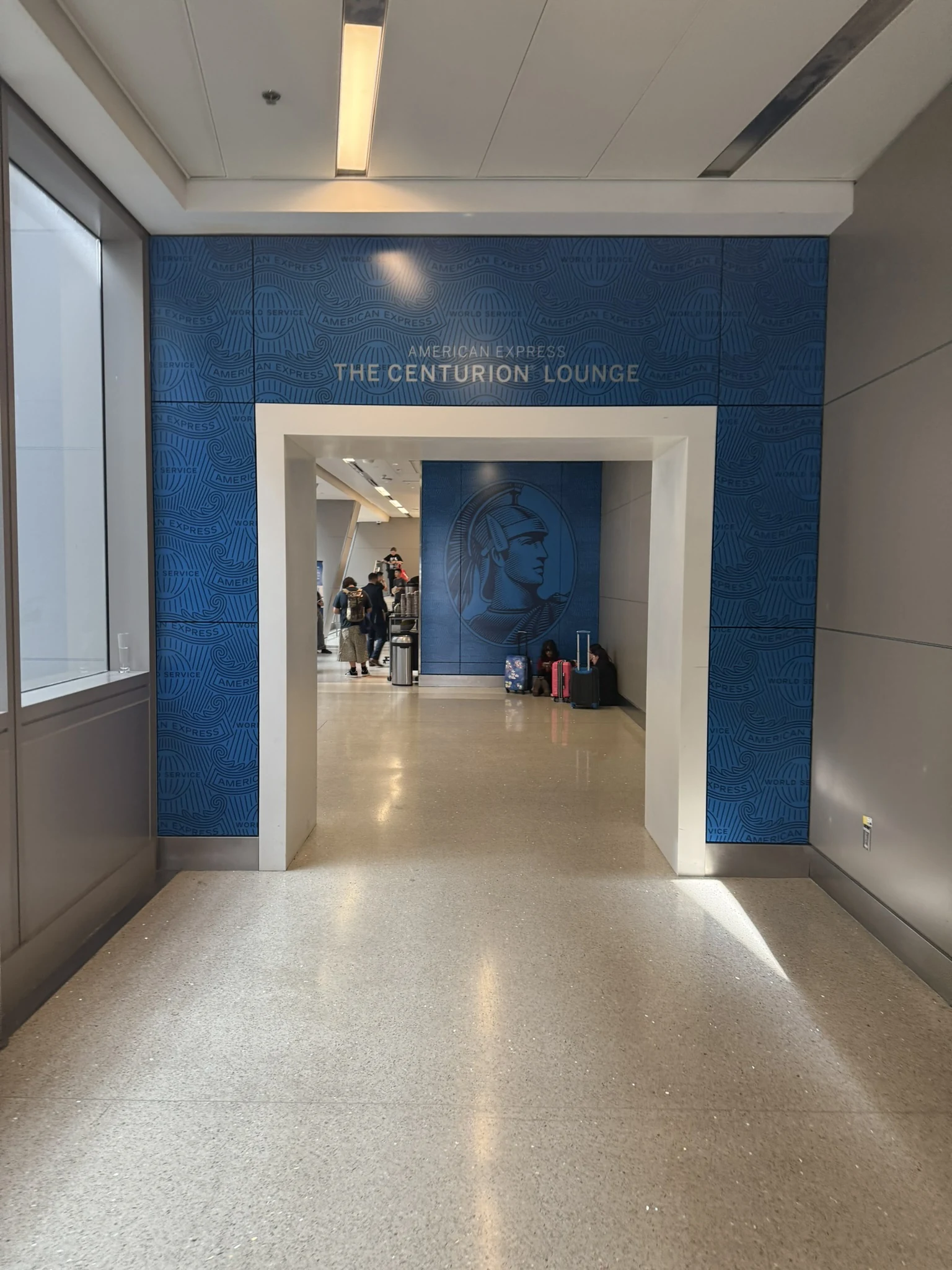 Blue entrance portal and Centurion mural at the American Express Centurion Lounge in Los Angeles International Airport.