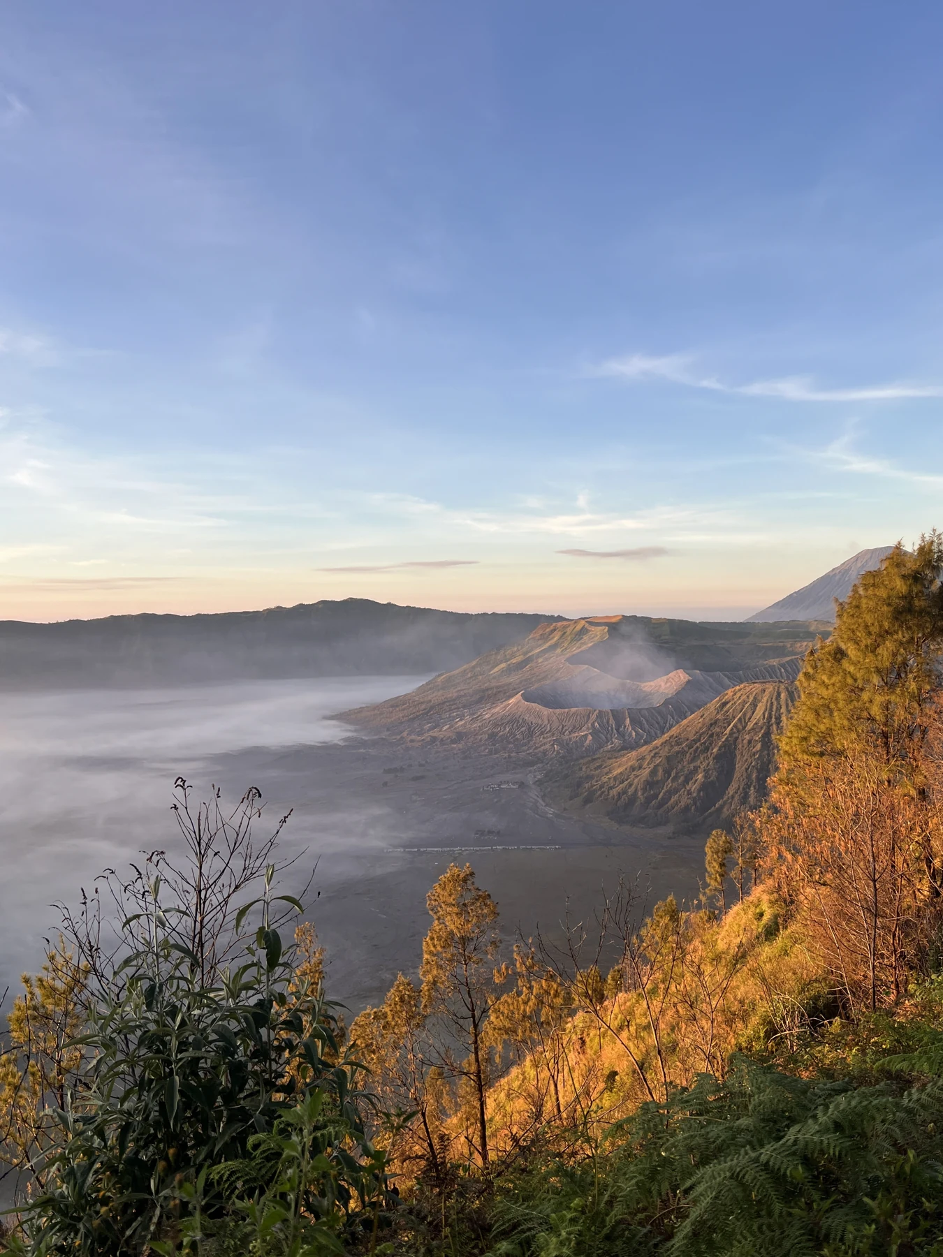 Morning light on the hills and mist around Bromo.