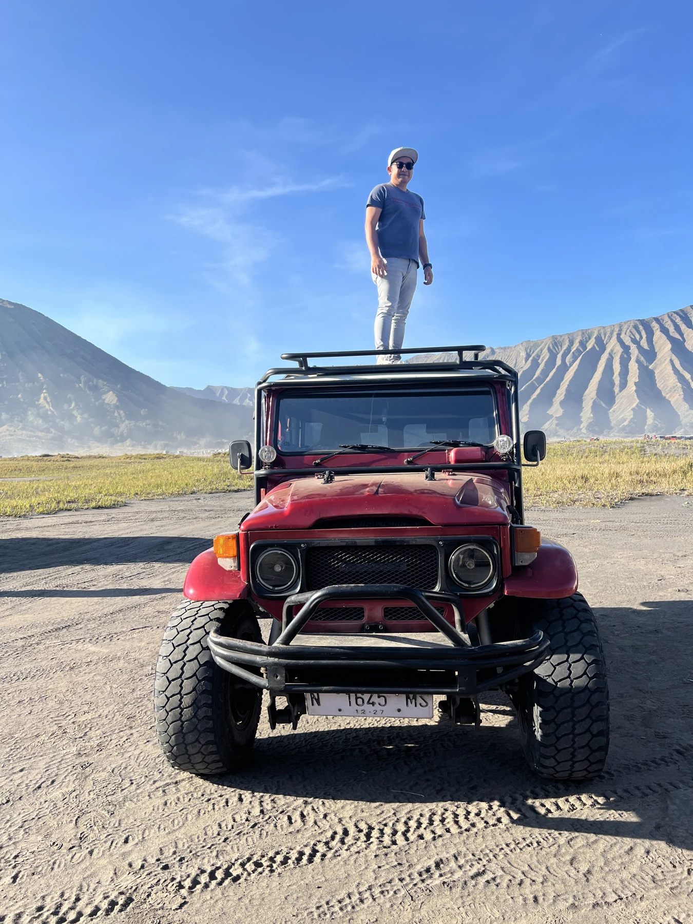 A Jeep on Bromo’s sea of sand after sunrise.